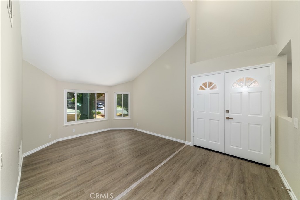 32465 Cape Cod Drive Lake Elsinore, CA 92530 - Photo 4 of 29 an empty room with wooden floor and window