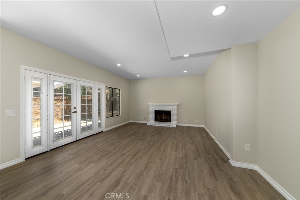 32465 Cape Cod Drive Lake Elsinore, CA 92530 - Photo 7 of 29 a view of an empty room with wooden floor and a window