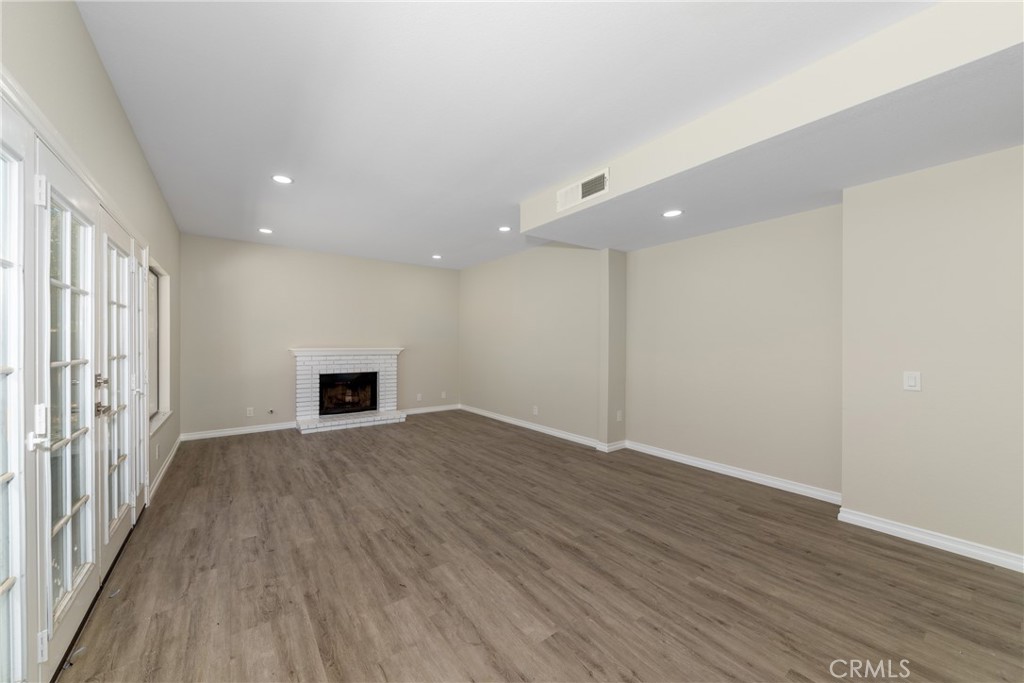 32465 Cape Cod Drive Lake Elsinore, CA 92530 - Photo 8 of 29 an empty room with wooden floor and windows