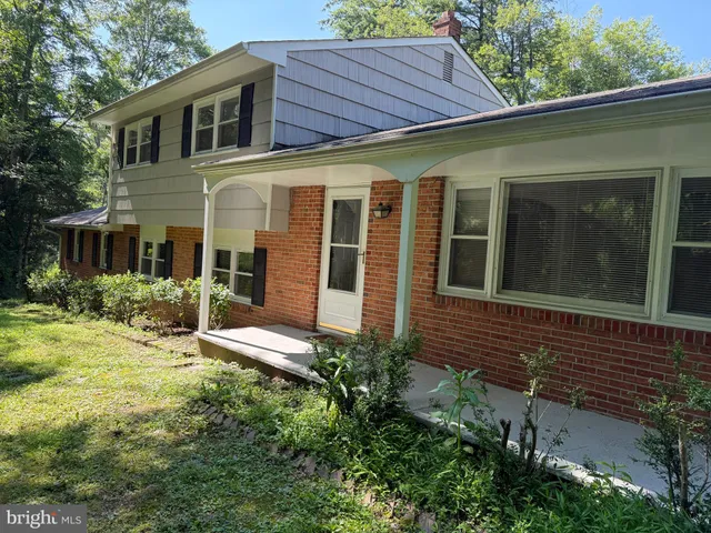 a view of a house with a yard and sitting area
