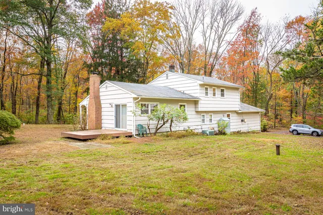 a front view of a house with swimming pool and porch with furniture