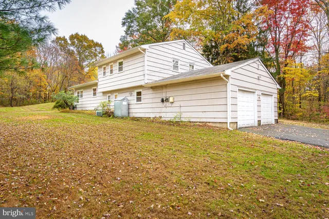 a view of a house with a yard and sitting area