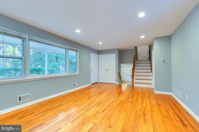 a view of a room with wooden floor and window