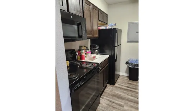 a kitchen with a sink and refrigerator