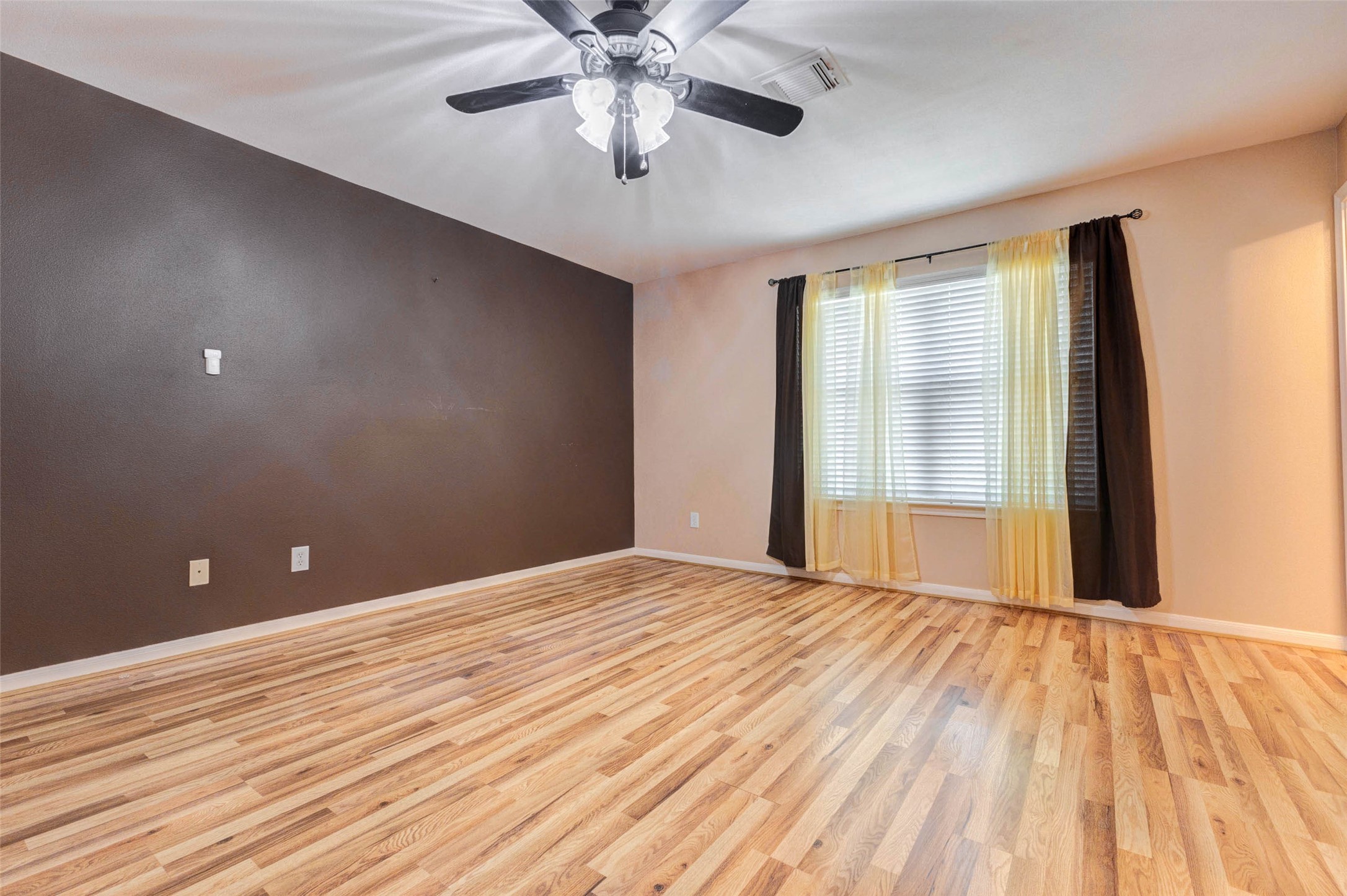 14522 Durham Chase Lane Houston, TX 77095 - Photo 25 of 40 a view of an empty room with wooden floor and a chandelier fan