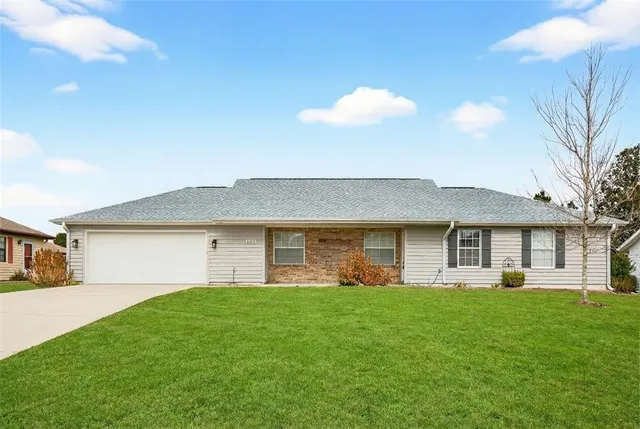 a front view of house with a garden and patio
