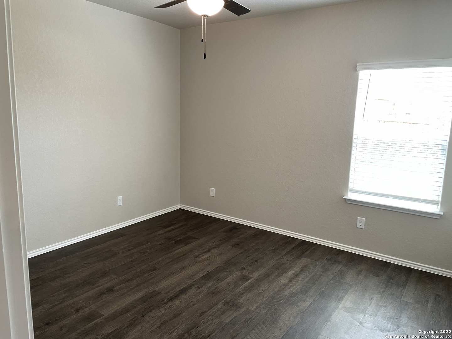 12904 Candace Way St. Hedwig, TX 78152 - Photo 7 of 15 an empty room with wooden floor and windows
