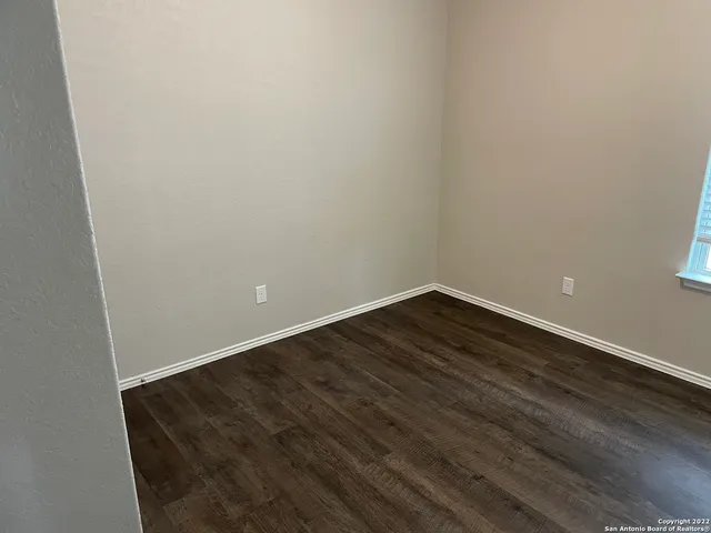 an empty room with wooden floor