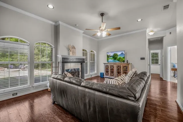 a living room with furniture a fireplace and a chandelier