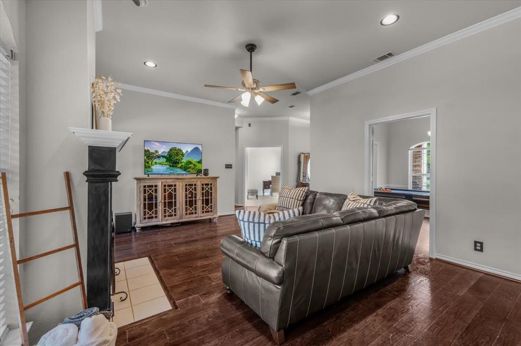 910 Crystal Cove Oak Point, TX 75068 - Photo 12 of 40 a living room with furniture a fireplace and a chandelier