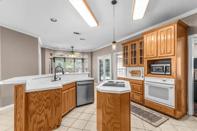 a kitchen with sink a refrigerator and wooden cabinets