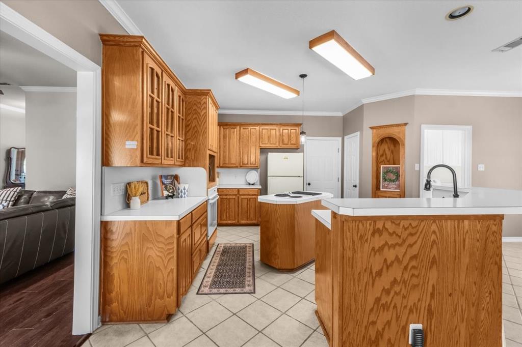 910 Crystal Cove Oak Point, TX 75068 - Photo 14 of 40 a kitchen with sink a refrigerator and wooden cabinets