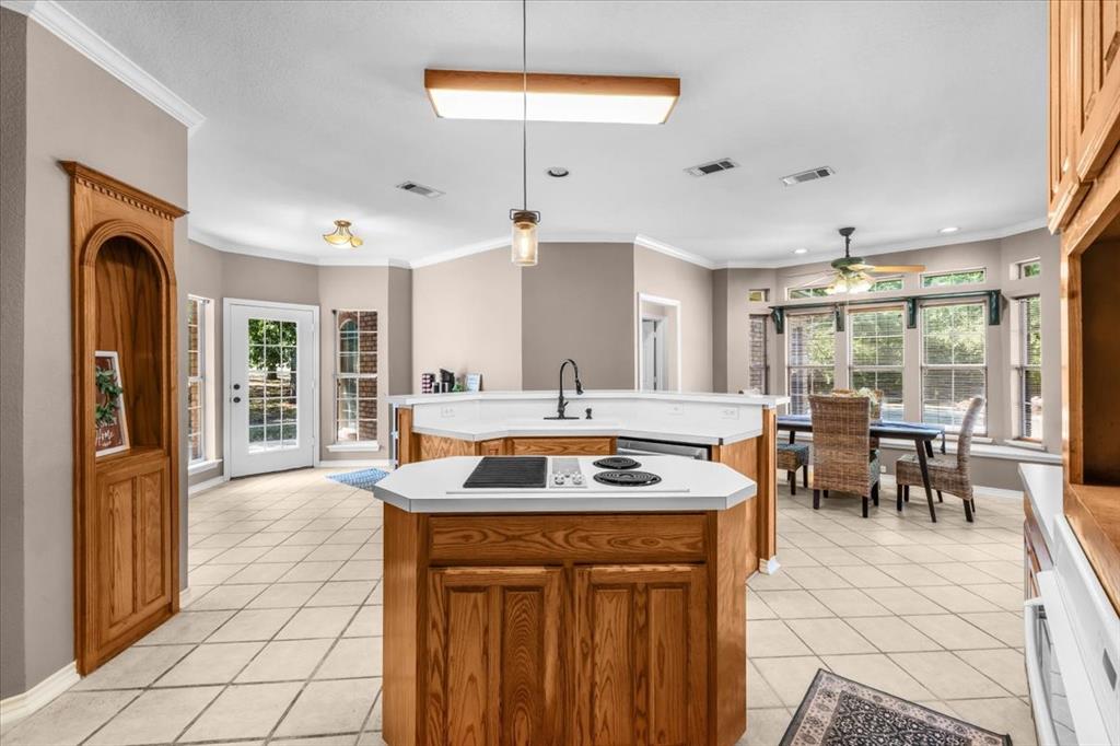 910 Crystal Cove Oak Point, TX 75068 - Photo 16 of 40 a kitchen with stainless steel appliances granite countertop a stove and a refrigerator