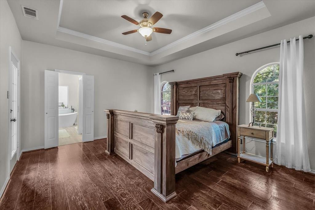 910 Crystal Cove Oak Point, TX 75068 - Photo 20 of 40 a bed room with a bed and a ceiling fan