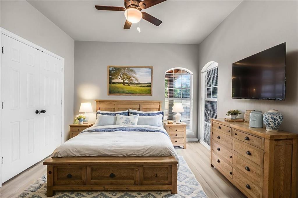 910 Crystal Cove Oak Point, TX 75068 - Photo 25 of 40 a bedroom with a bed and a flat screen tv