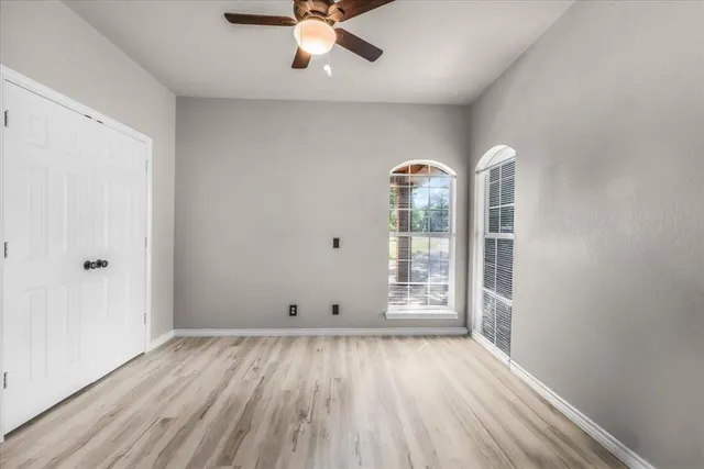 a bedroom with a bed and a flat tv screen on dresser