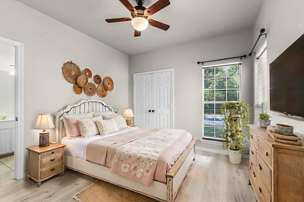 910 Crystal Cove Oak Point, TX 75068 - Photo 27 of 40 a bedroom with a bed and a flat tv screen on dresser