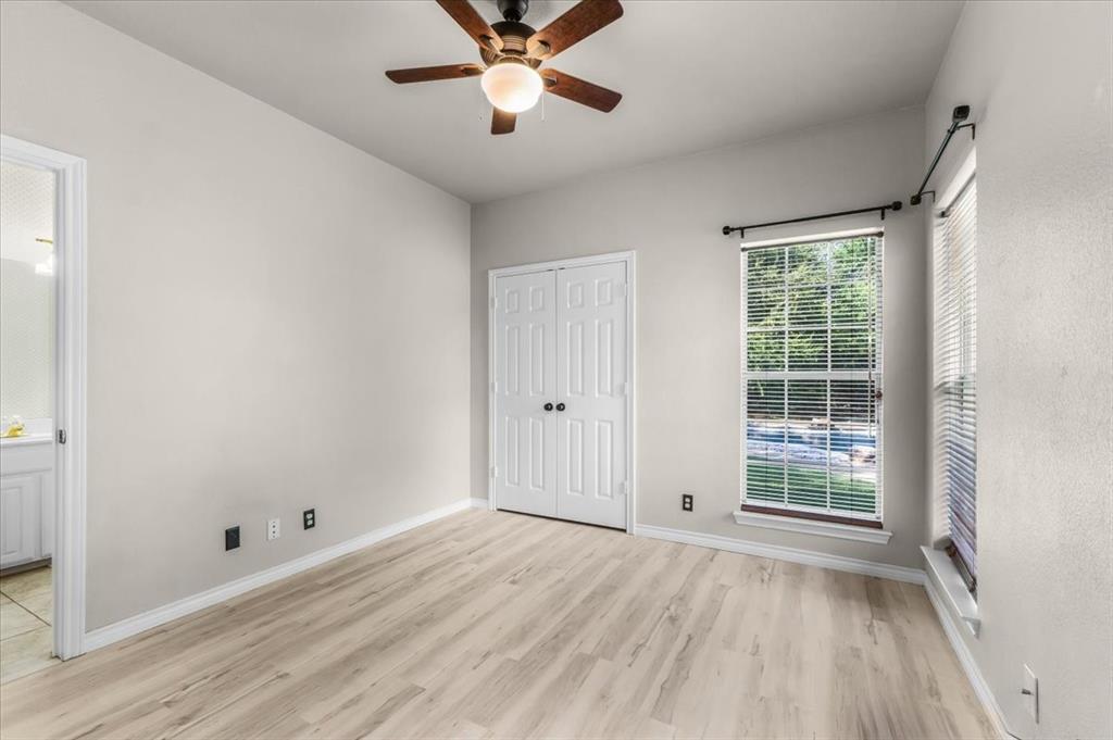 910 Crystal Cove Oak Point, TX 75068 - Photo 28 of 40 a view of an empty room with a window and wooden floor
