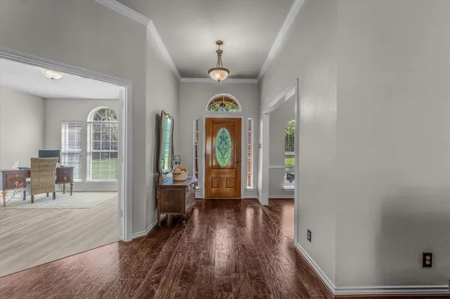 a room with pool table and windows
