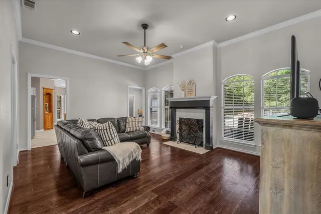 a living room with furniture a fireplace and a large window