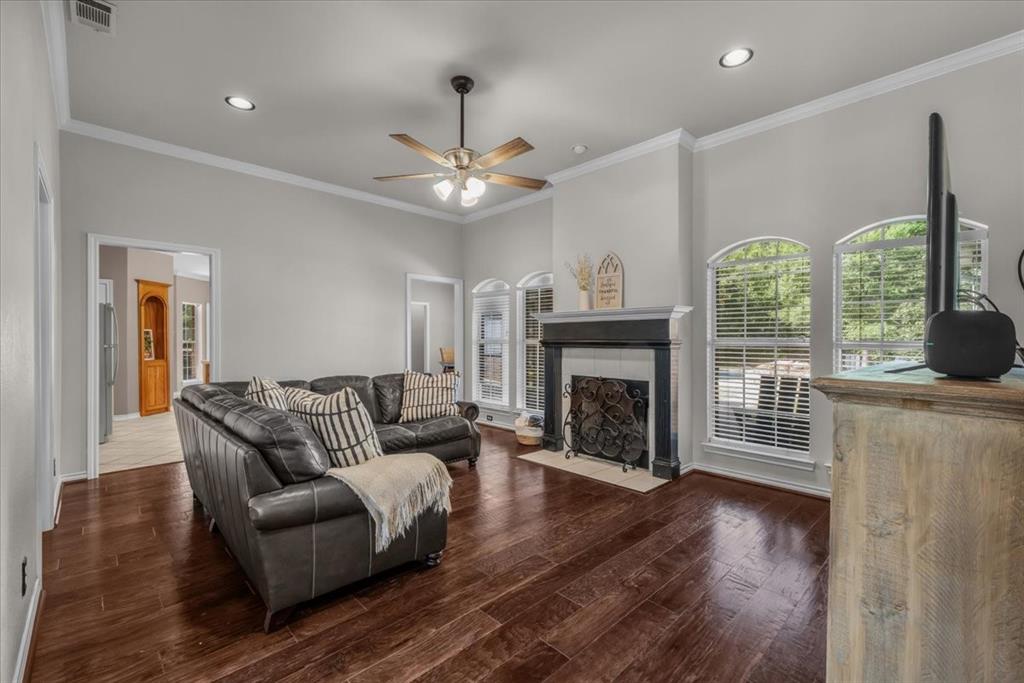 910 Crystal Cove Oak Point, TX 75068 - Photo 10 of 40 a living room with furniture fireplace and a large window