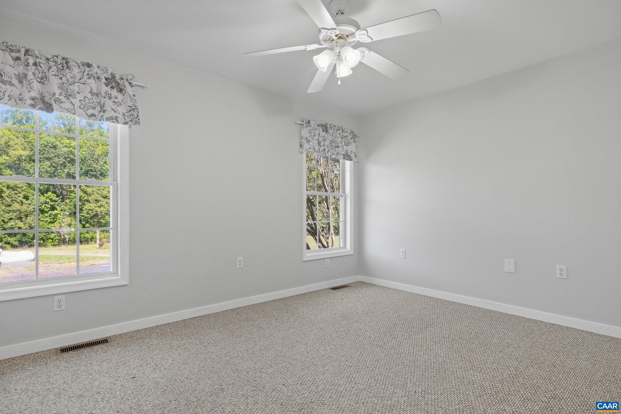 1075 Social Hall Road New Canton, VA 23123 - Photo 60 of 64 an empty room with a window and a fan