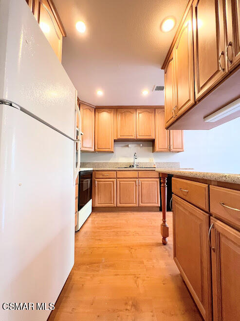 a kitchen with stainless steel appliances granite countertop a sink counter space cabinets and a large window
