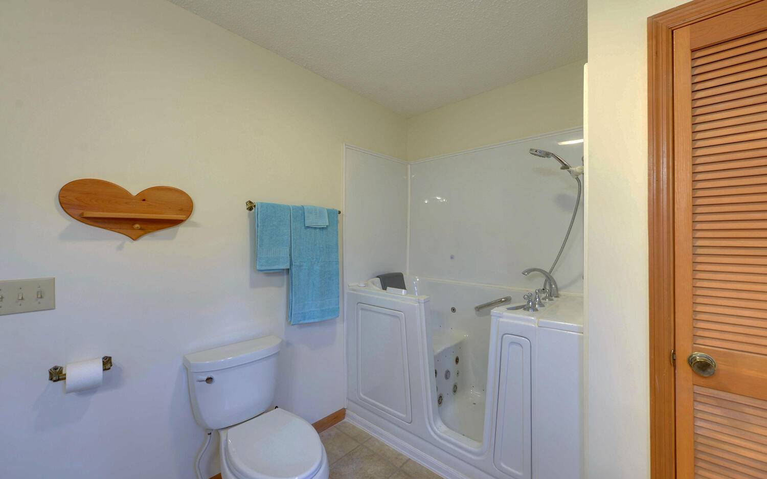 2139 Lake Louisa Road Hiawassee, GA 30546 - Photo 12 of 48 a white toilet sitting next to a bathroom sink