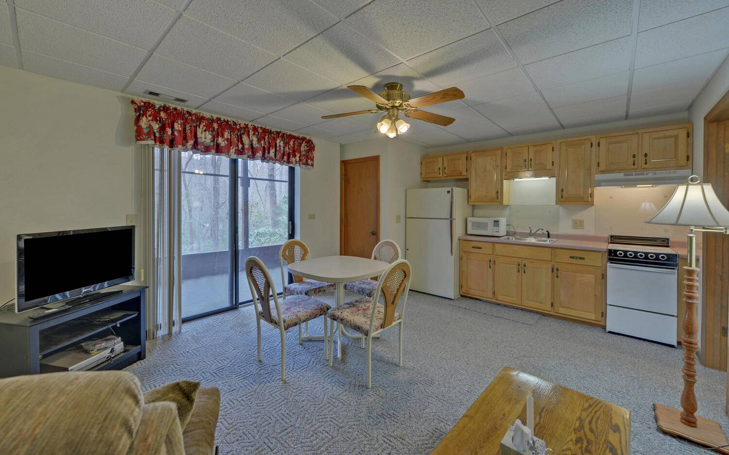 2139 Lake Louisa Road Hiawassee, GA 30546 - Photo 18 of 48 a living room with furniture a flat screen tv and kitchen view