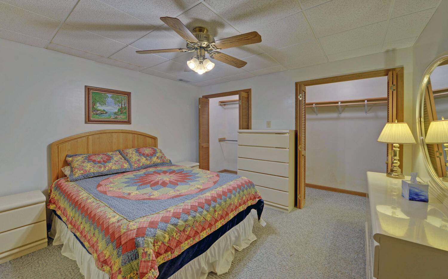 2139 Lake Louisa Road Hiawassee, GA 30546 - Photo 19 of 48 a bedroom with a bed and a chandelier