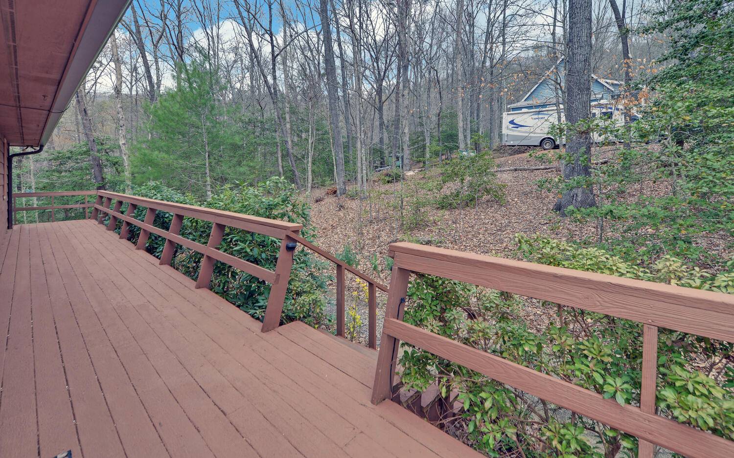 2139 Lake Louisa Road Hiawassee, GA 30546 - Photo 28 of 48 a view of a wooden deck and trees with wooden fence