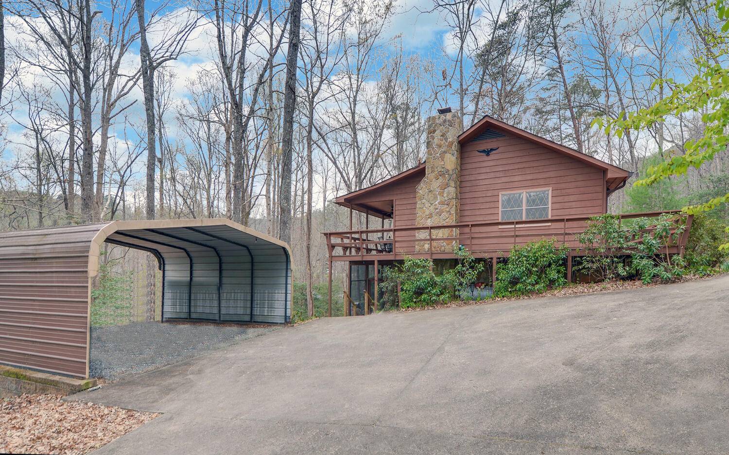 2139 Lake Louisa Road Hiawassee, GA 30546 - Photo 35 of 48 a front view of a house with garden