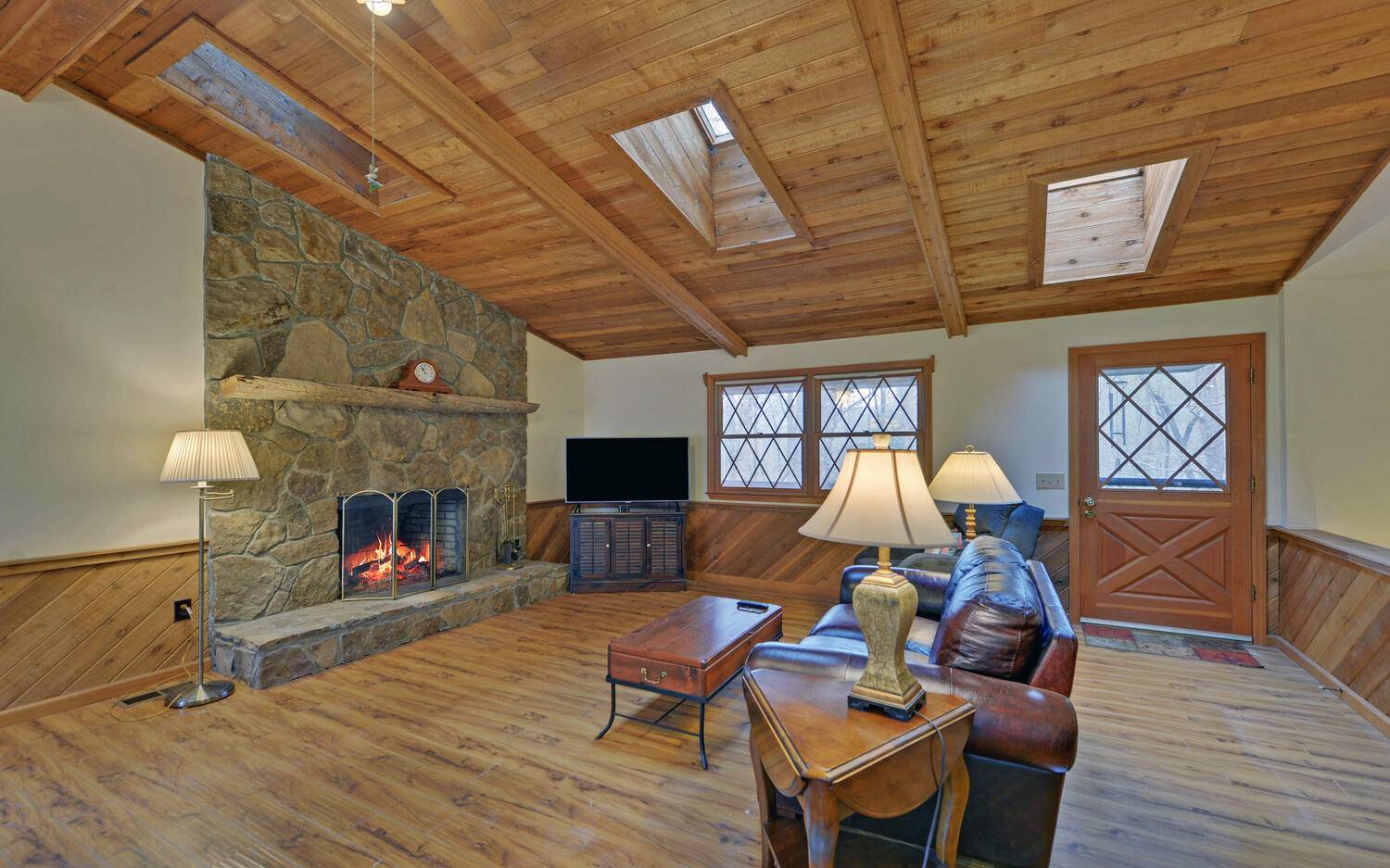 2139 Lake Louisa Road Hiawassee, GA 30546 - Photo 6 of 48 a living room with furniture a fireplace and wooden floor