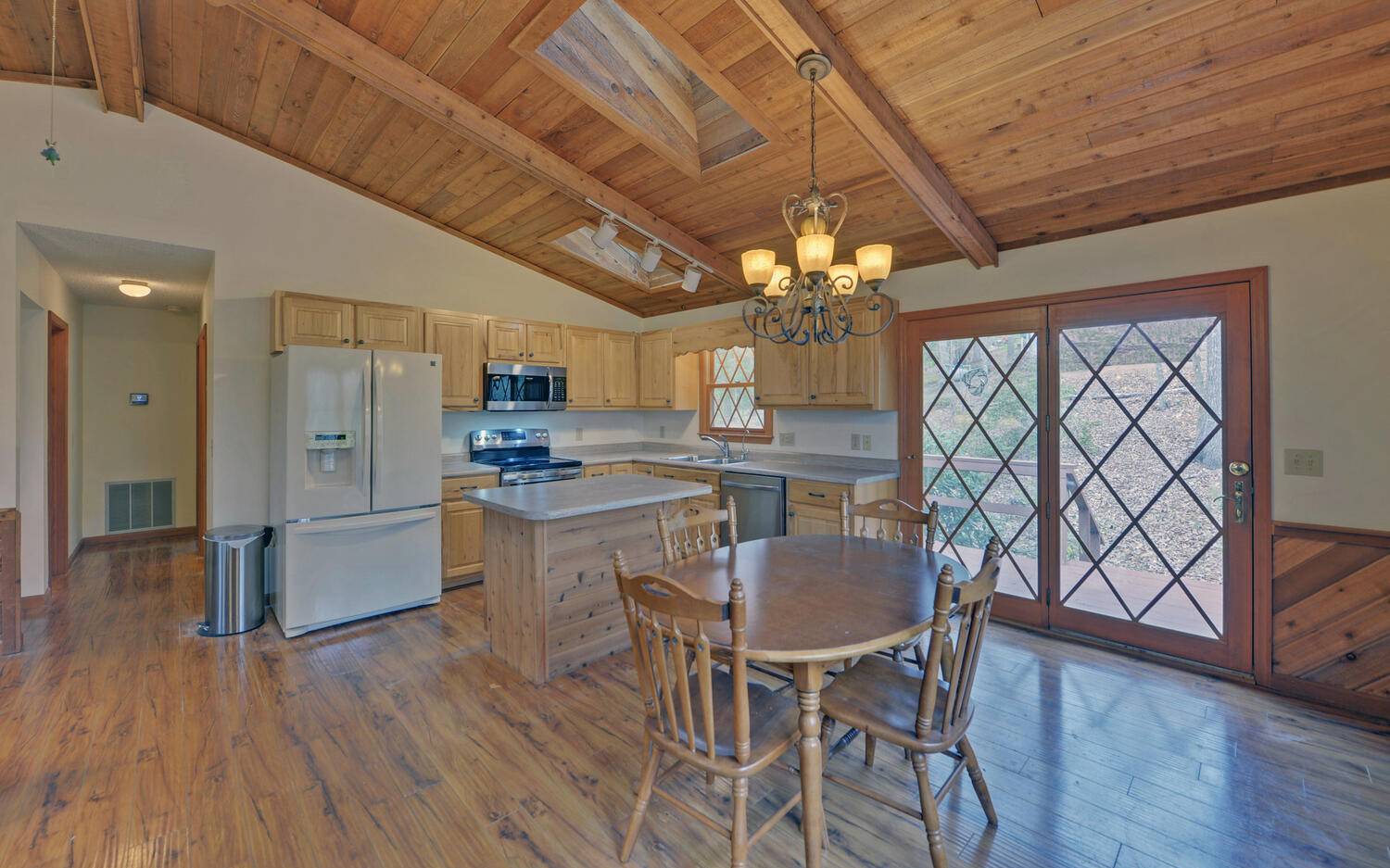 2139 Lake Louisa Road Hiawassee, GA 30546 - Photo 10 of 48 a kitchen with stainless steel appliances granite countertop a kitchen island a stove a table and chairs with wooden floor