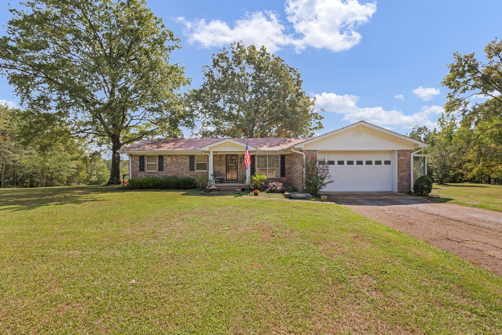 a front view of a house with a garden and deck