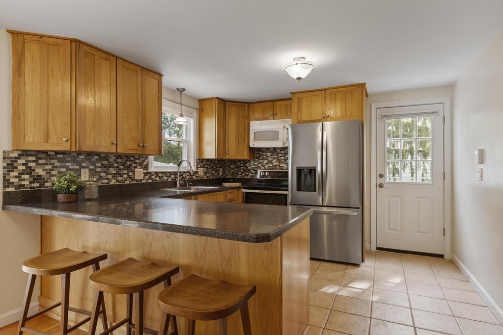 6 Edith Road Hudson, MA 01749 - Photo 6 of 30 a kitchen with stainless steel appliances granite countertop a refrigerator a stove and a sink with granite countertops