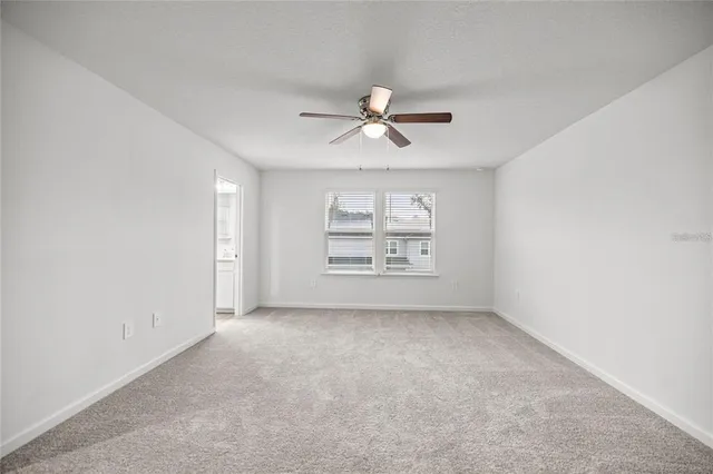 a view of a hallway with wooden floor and entryway