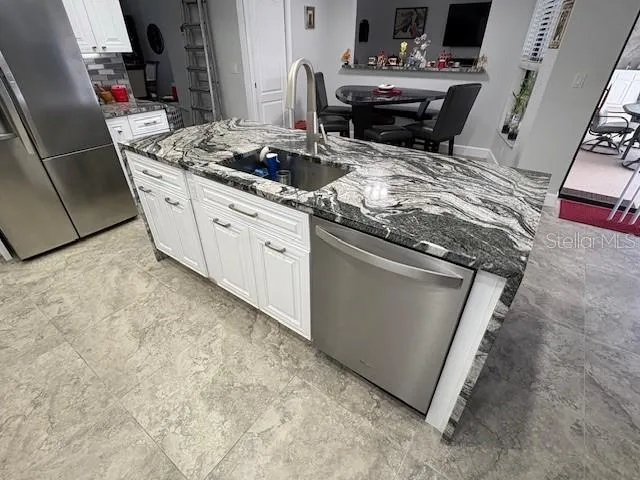 a bedroom with a large bed and a flat screen tv