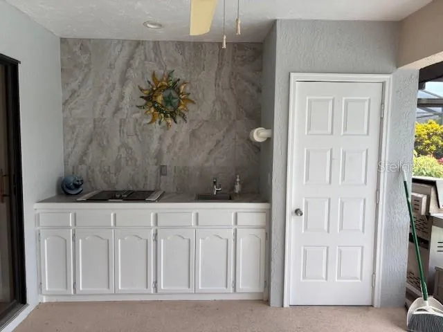 a bathroom with a granite countertop toilet sink mirror and vanity