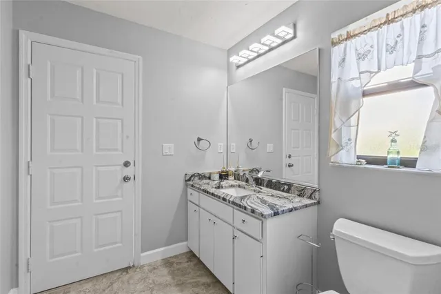 a bathroom with a bathtub sink and mirror