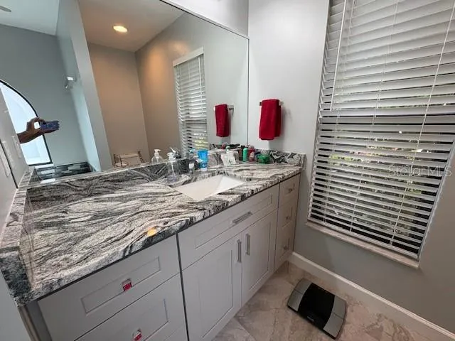 a view of a house with a yard and potted plants