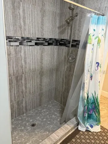 an aerial view of a house with a yard swimming pool and outdoor seating