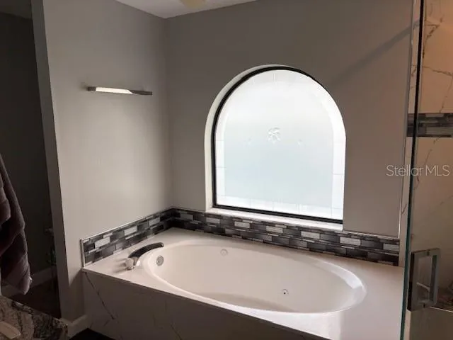 a view of a dining room with furniture and a window