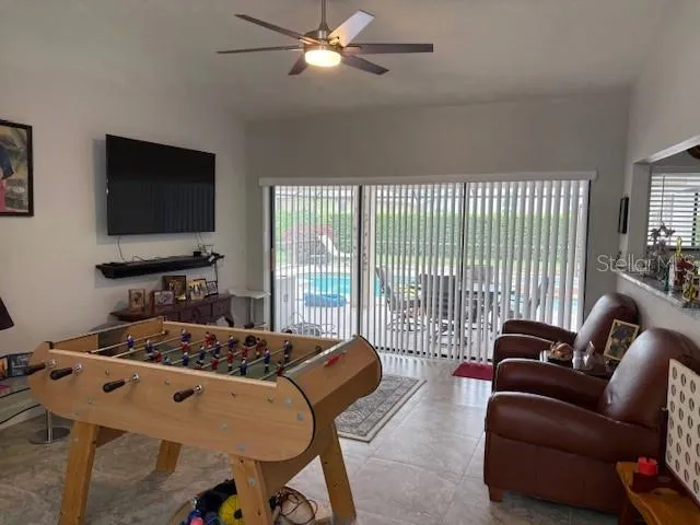 a kitchen with refrigerator and chairs