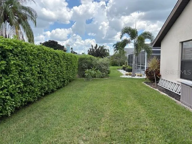 a bathroom with a granite countertop sink a large mirror and a shower