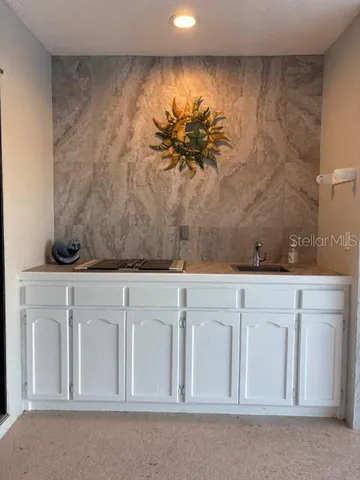 a utility room with sink dryer and washer