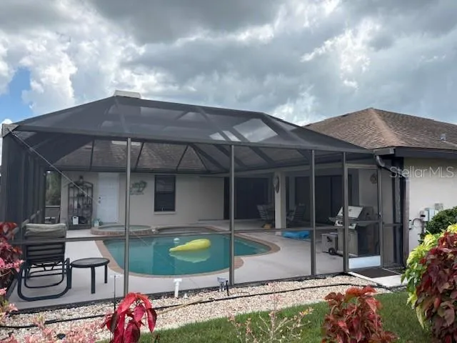 a kitchen with granite countertop a sink stove and refrigerator