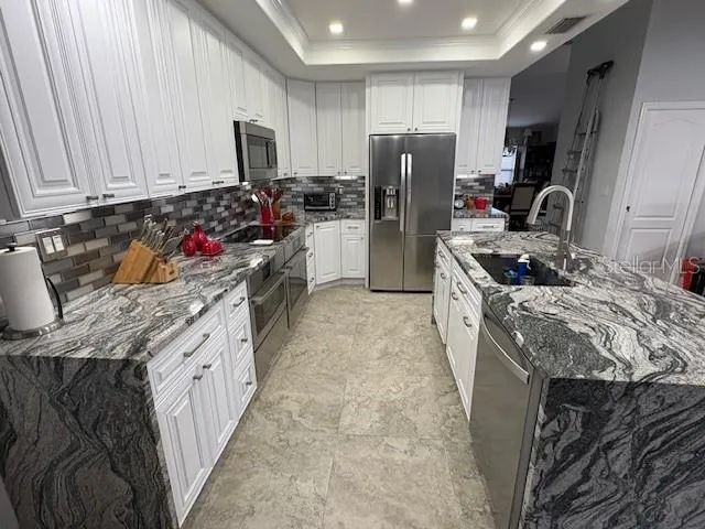 a view of a dining room with furniture and chandelier