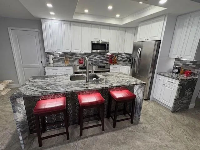 a view of a dining room with furniture and a window