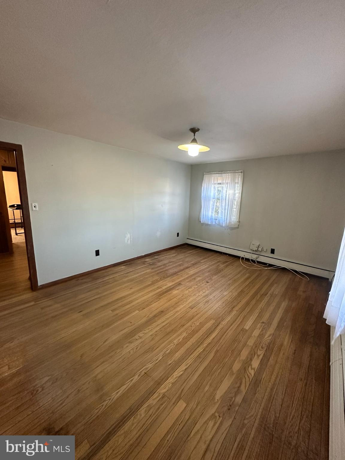 809 Somerdale Road Voorhees, NJ 08043 - Photo 12 of 20 an empty room with wooden floor and windows